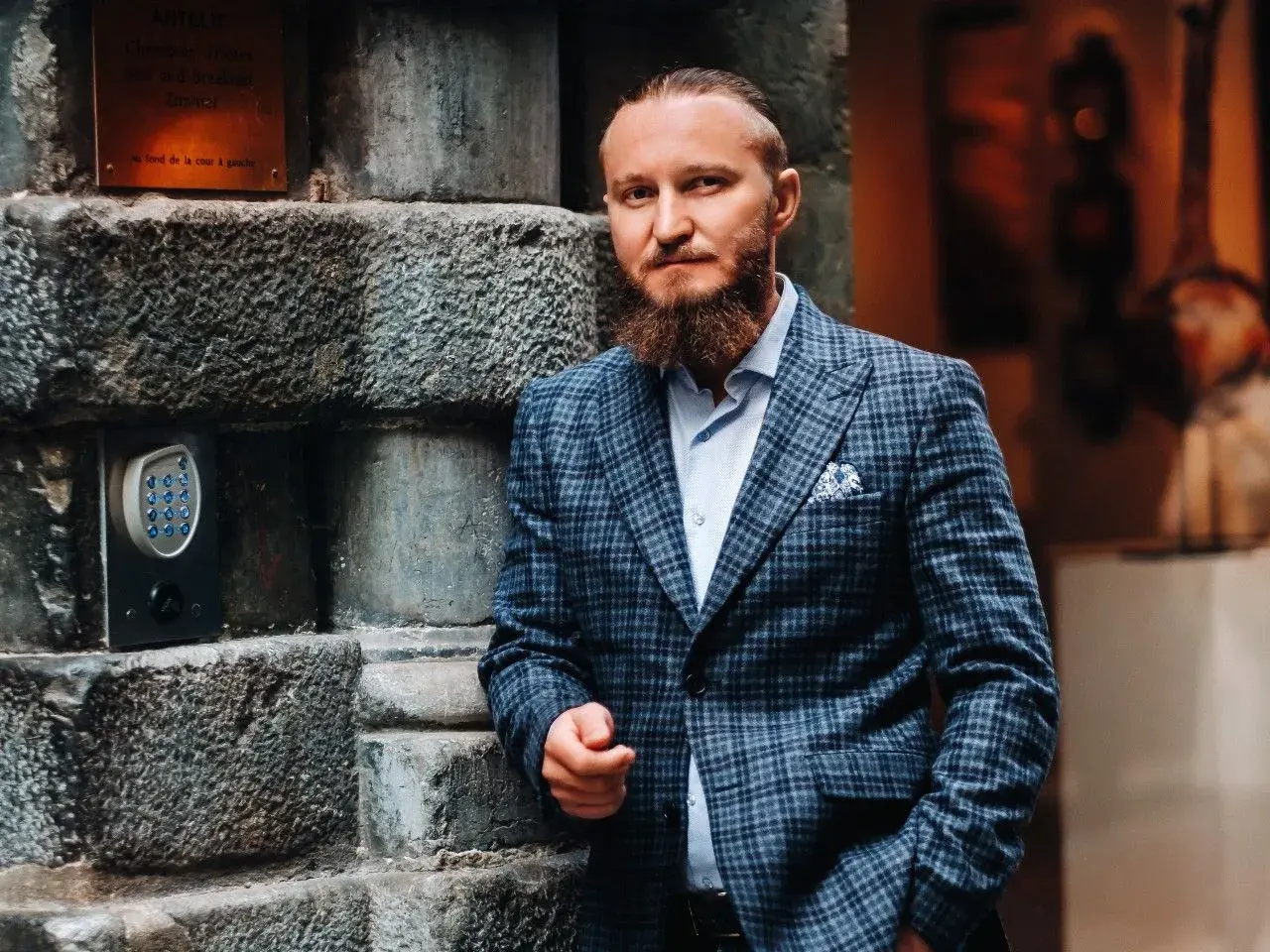 Elegancki mężczyzna w garniturze w kratę. Zastanawiasz się, jaki krawat do garnituru w kratę będzie najlepszy? Ten styl to klasa sama w sobie.