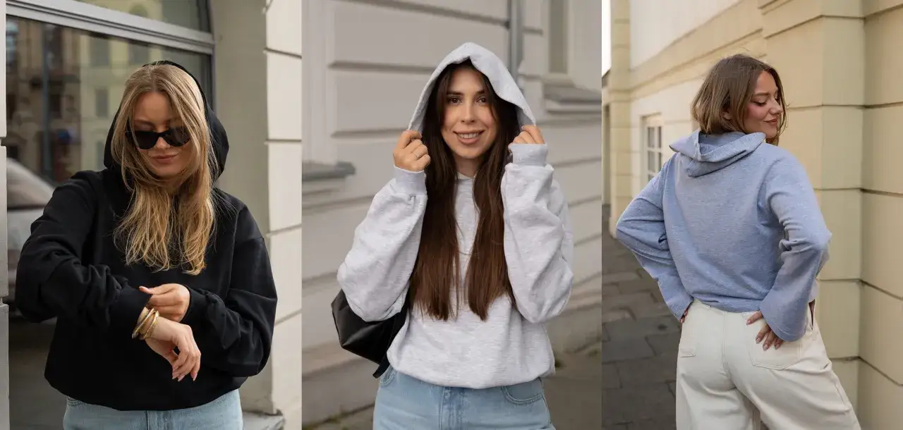 Trzy dziewczyny prezentują wygodny styl ubioru młodzieży: bluzy z kapturem i jeansy.